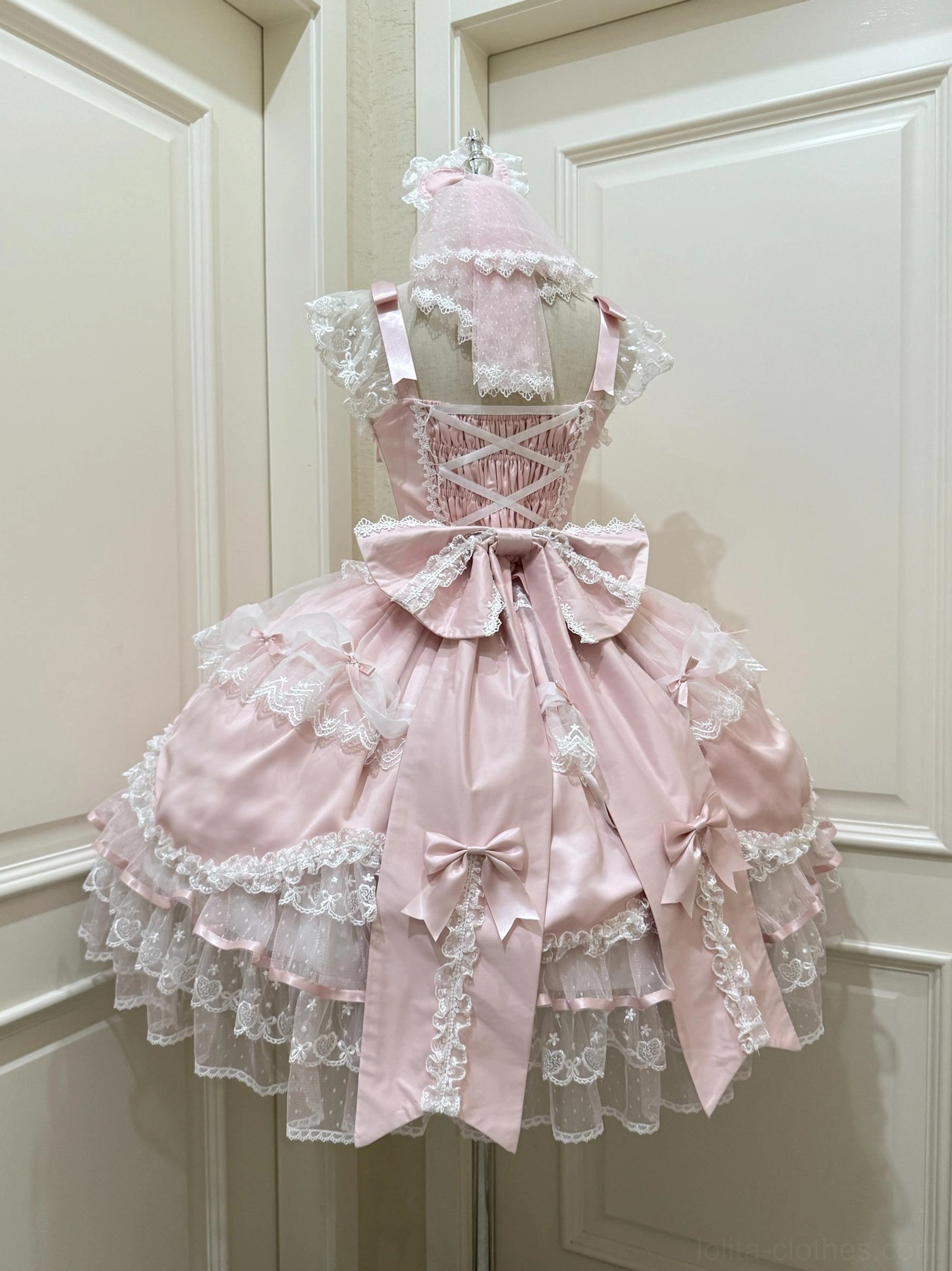 Sweet Lolita JSK jumper dress back view pink-white cross lace-up large satin bow ruffled lace hem dress mannequin