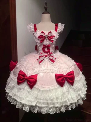 Pink-white floral sweet lolita JSK dress with tiered lace layers, red satin bows, and rhinestone chest decoration on display mannequin front view