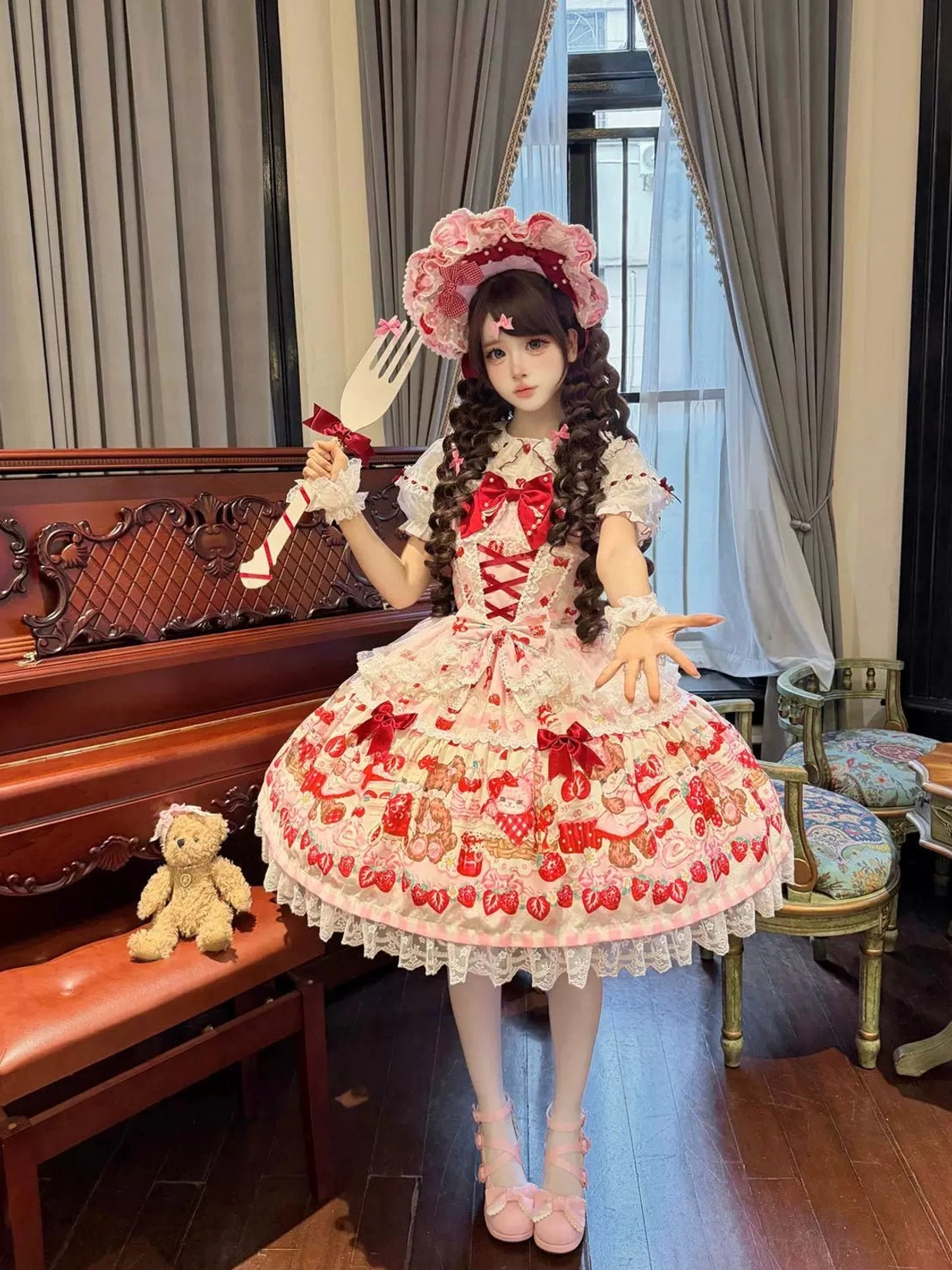 Sweet lolita JSK dress close-up detail of strawberry print pattern and delicate lace ruffle construction
