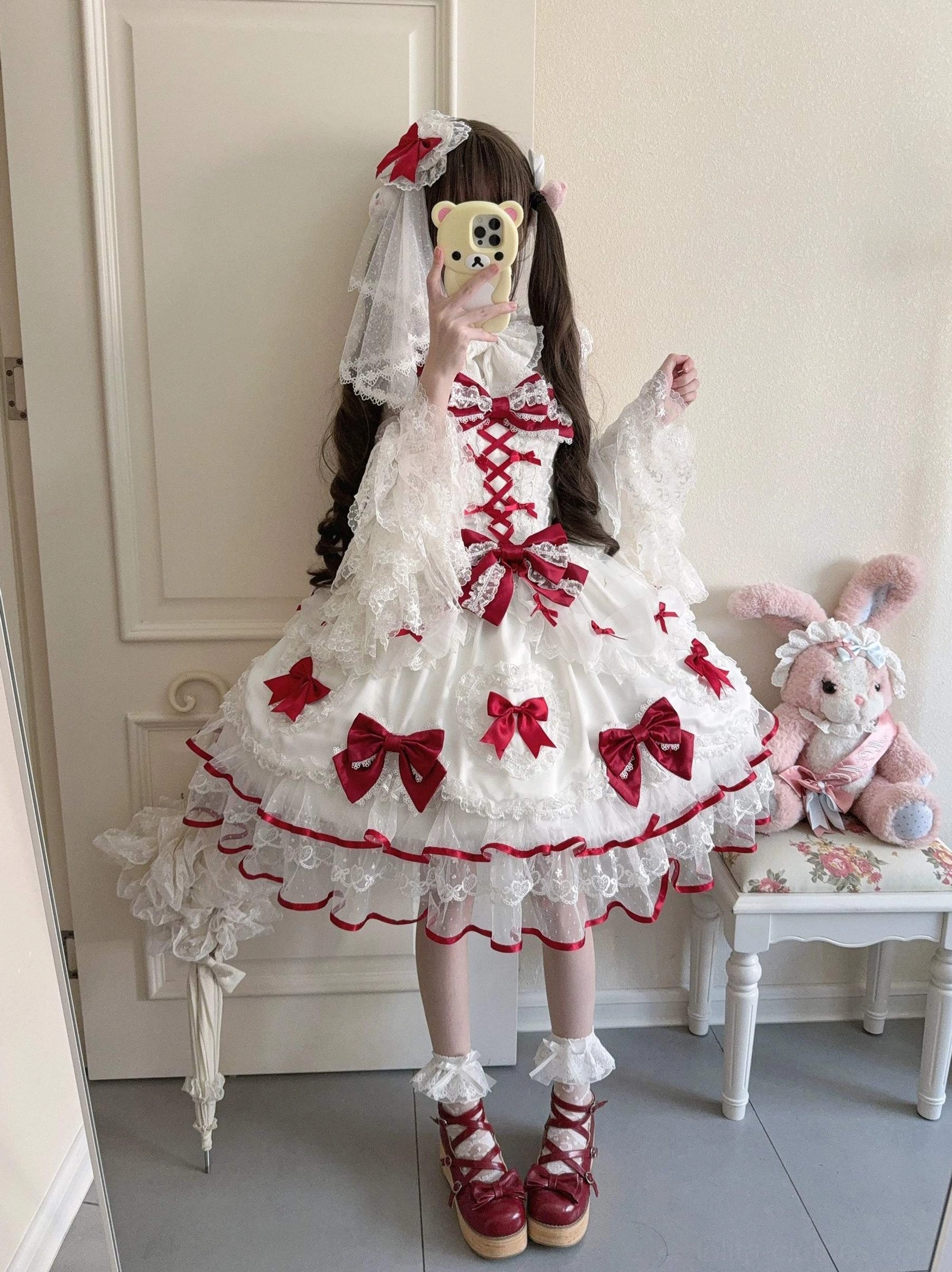 Sweet Lolita JSK jumper dress on model mirror selfie white-red cross lace-up front red satin bows matching red lolita shoes