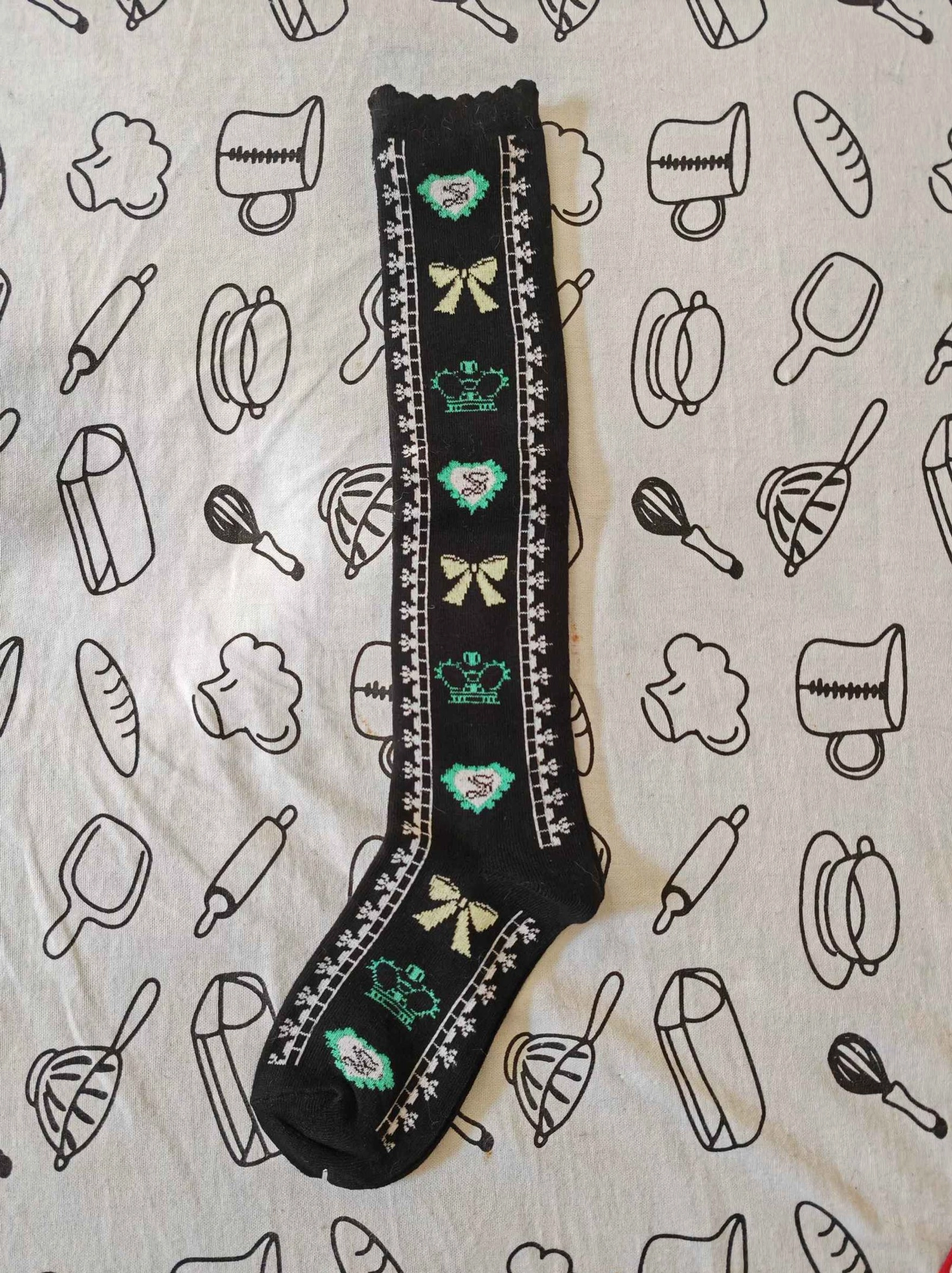 sweet-lolita-knee-high-cotton-socks-black-base-mint-green-beige-crown-bow-heart-prints-scalloped-ruffled-cuff-flat-lay-top-down-view
