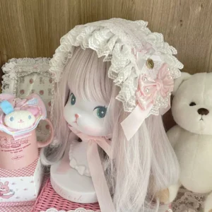 Sweet Lolita lace bonnet hairband with white ruffled lace trim, pink satin bows, faux pearls and gold heart charm details, handmade headdress front three-quarter view