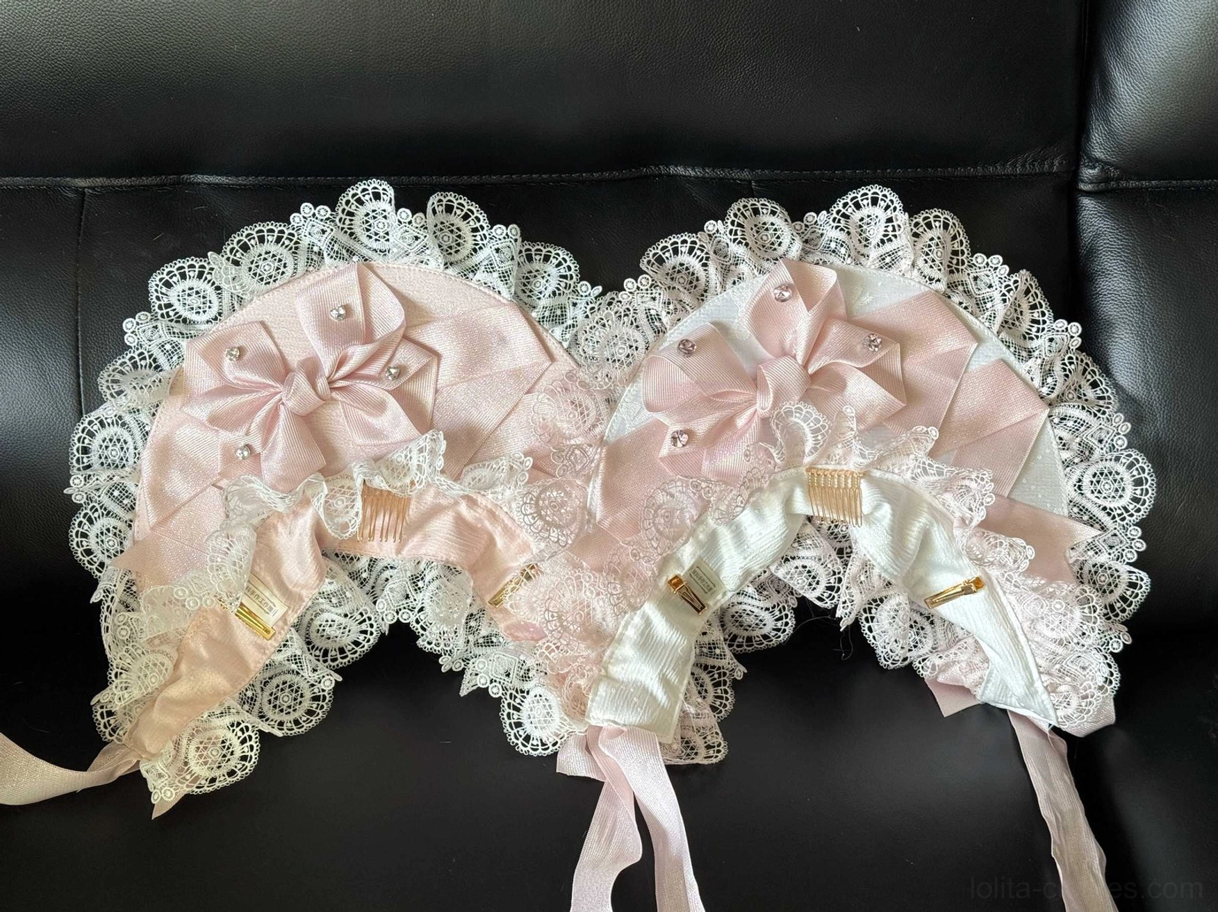 Two matching Sweet Lolita lace head bonnets in two-tone pink satin, white ruffled lace trim, built-in hair combs, coordinating neck ribbons, pearl decorations, flat lay display