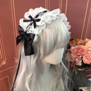Sweet lolita double-layer lace headband with black satin bows and flowing ribbons, styled on mannequin with silver-white long wig and rose flower bouquet backdrop, three-quarter front view showing white ruffled lace base