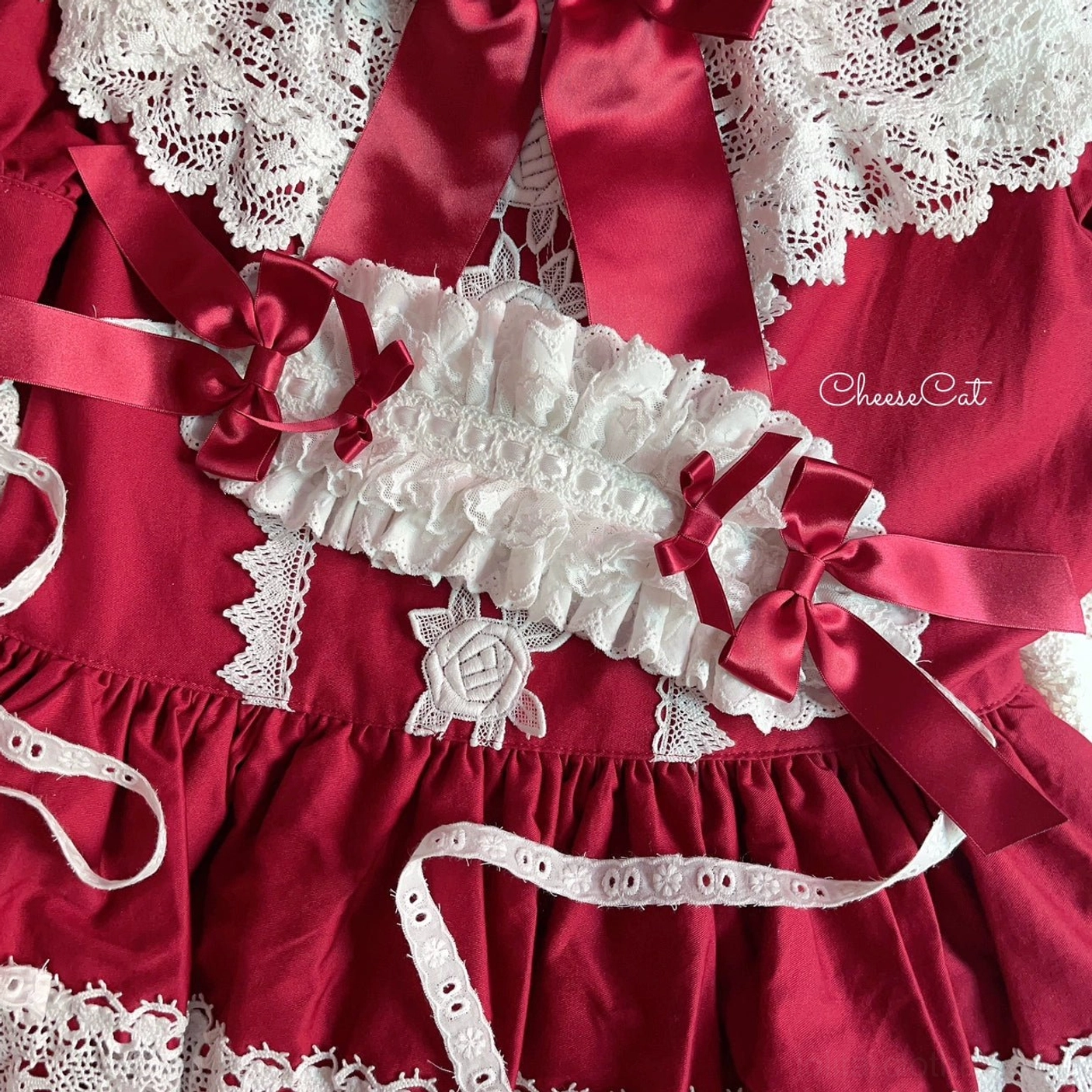 Sweet Lolita lace hair headband with oversized satin bow and delicate ruffled trim detail photographed in natural lighting