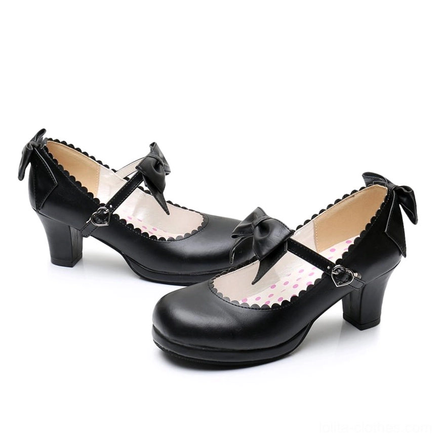 Black sweet Lolita Mary Jane platform heels flat lay overhead shot displaying ankle bow scalloped inner lining polka dot insole and block heel construction