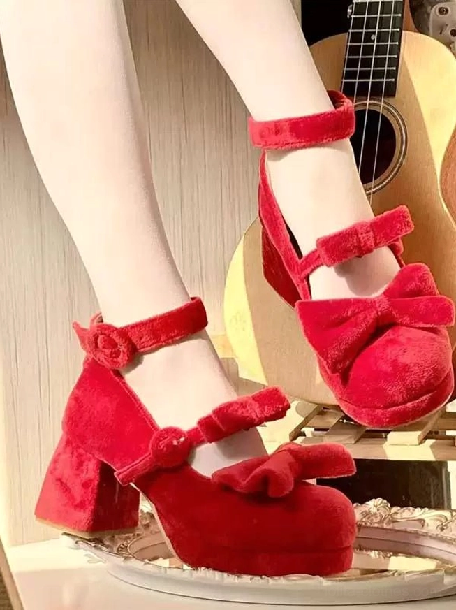 Bright red velvet sweet lolita chunky heel mary jane shoes worn on feet from top down view with white stockings