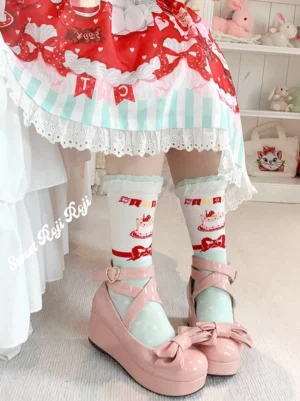Sweet Lolita mint green ruffle socks with cute cat holiday prints worn with pink platform Mary Jane shoes and mint striped lace Lolita skirt front view
