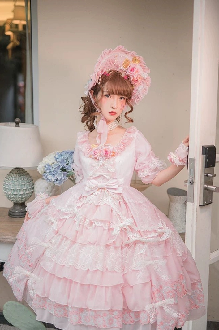Sweet Lolita OP dress featuring removable waist bow, multi-layered ruffle hem with lace trim, and elegant silhouette detail