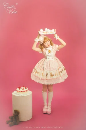Sweet lolita OP dress with teddy bear and bakery print standing full body pose pink background model