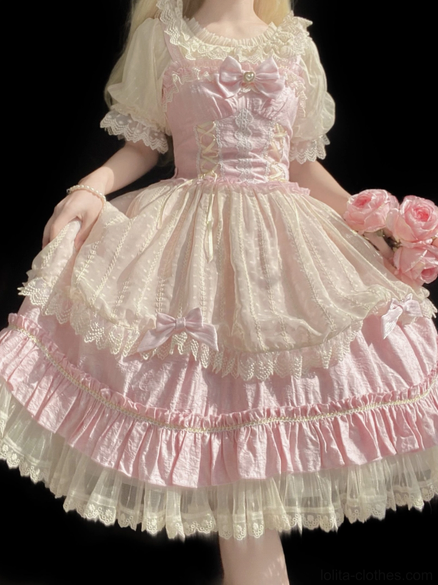 Two-tone pink sweet Lolita op dress full front view on model featuring layered ruffled lace skirt, front bow accents, corset-style bodice and matching puff sleeves