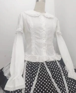 Sweet Lolita Peter Pan collar blouse front view with long flared lace sleeves and ruffled hem, paired with black and white polka dot skirt, short puff sleeves detail