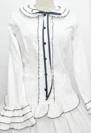 Sweet Lolita Peter Pan collar blouse white base with black ruffled lace trim and heart-shaped black buttons front view