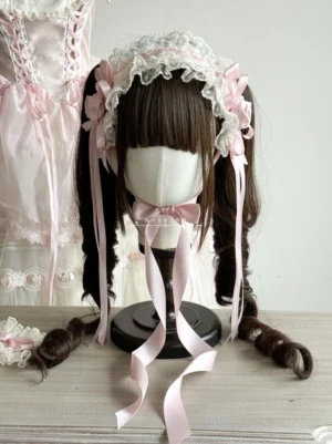 Sweet Lolita pink floral bow headband with long ribbon streamers three-quarter view on wig stand with lolita dress backdrop