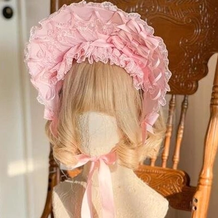 Sweet lolita pink lace bonnet front view on mannequin, fluffy pink ruffled brim with lace trim, matching pink satin chin straps