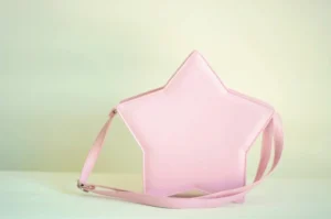 Pastel pink five-pointed star Lolita crossbody bag front flat view, handcrafted PU leather Sweet Lolita messenger with star-shaped design and adjustable shoulder strap