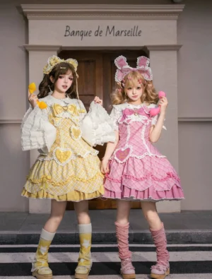 Plus-size sweet lolita plaid OP dress front full-body double model view with detachable oversized collar bows and heart patches, yellow and pink gingham pattern with ruffled lace trim and bunny ear hair accessories worn by models on retro French storefront