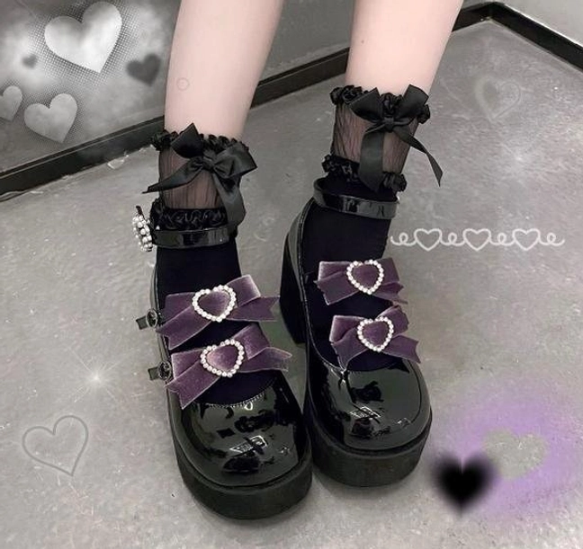 Sweet lolita platform heel shoes heart buckle decoration detail close-up showing punk romantic design element patent leather finish