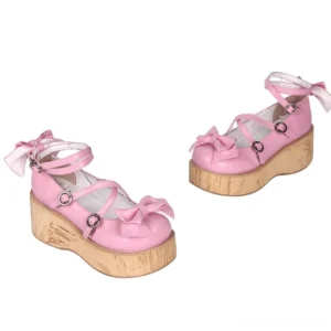 Single sweet Lolita Mary Jane shoe left three-quarter angle showing pink microfiber leather construction, front toe bow decoration, cross buckle strap closure, and wood-grain textured outsole