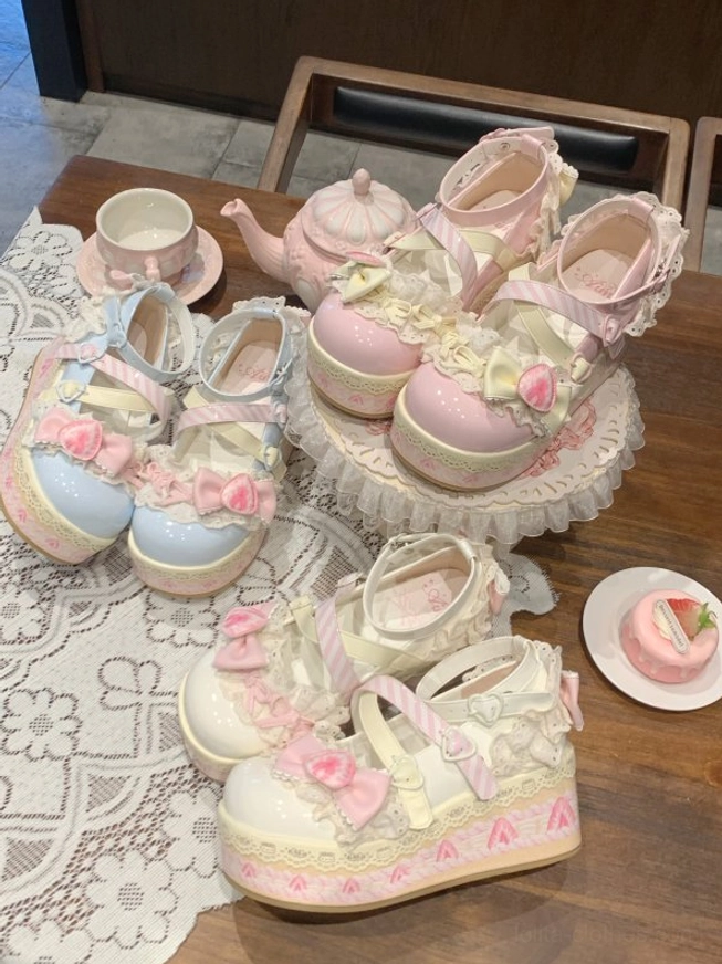 Sweet lolita platform shoes overhead flat lay multiple color options with bows lace and floral elements platform sole printed edge patterns on tea table with teapot
