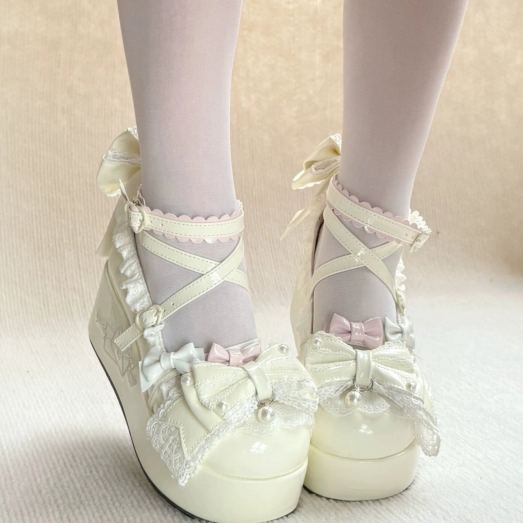 Sweet Lolita platform shoes texture close-up showing glossy patent leather finish, ruffled surface details, faux pearl embellishments, and premium material quality construction