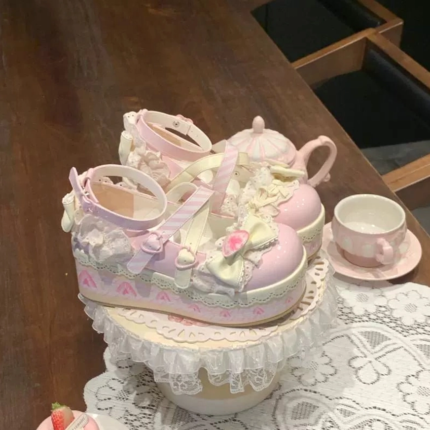 Sweet lolita platform shoes clean studio product display white background pink patent leather creamy yellow lace trims bow heart flower striped cross ankle straps