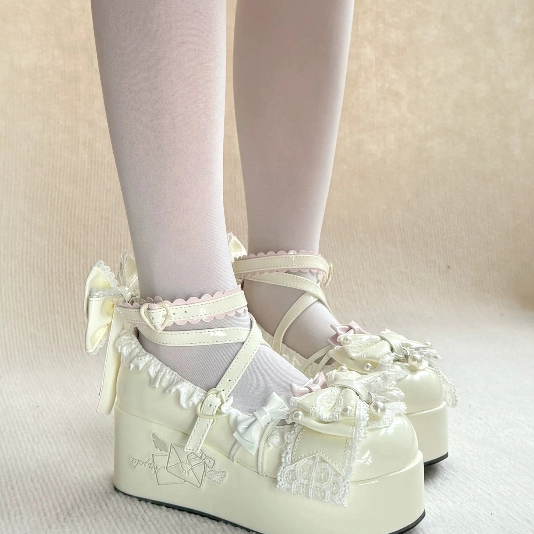 Sweet Lolita platform shoes vamp design detail featuring embroidered envelope motif, lace trim pattern, bowknot placement, and decorative element arrangement on shoe front
