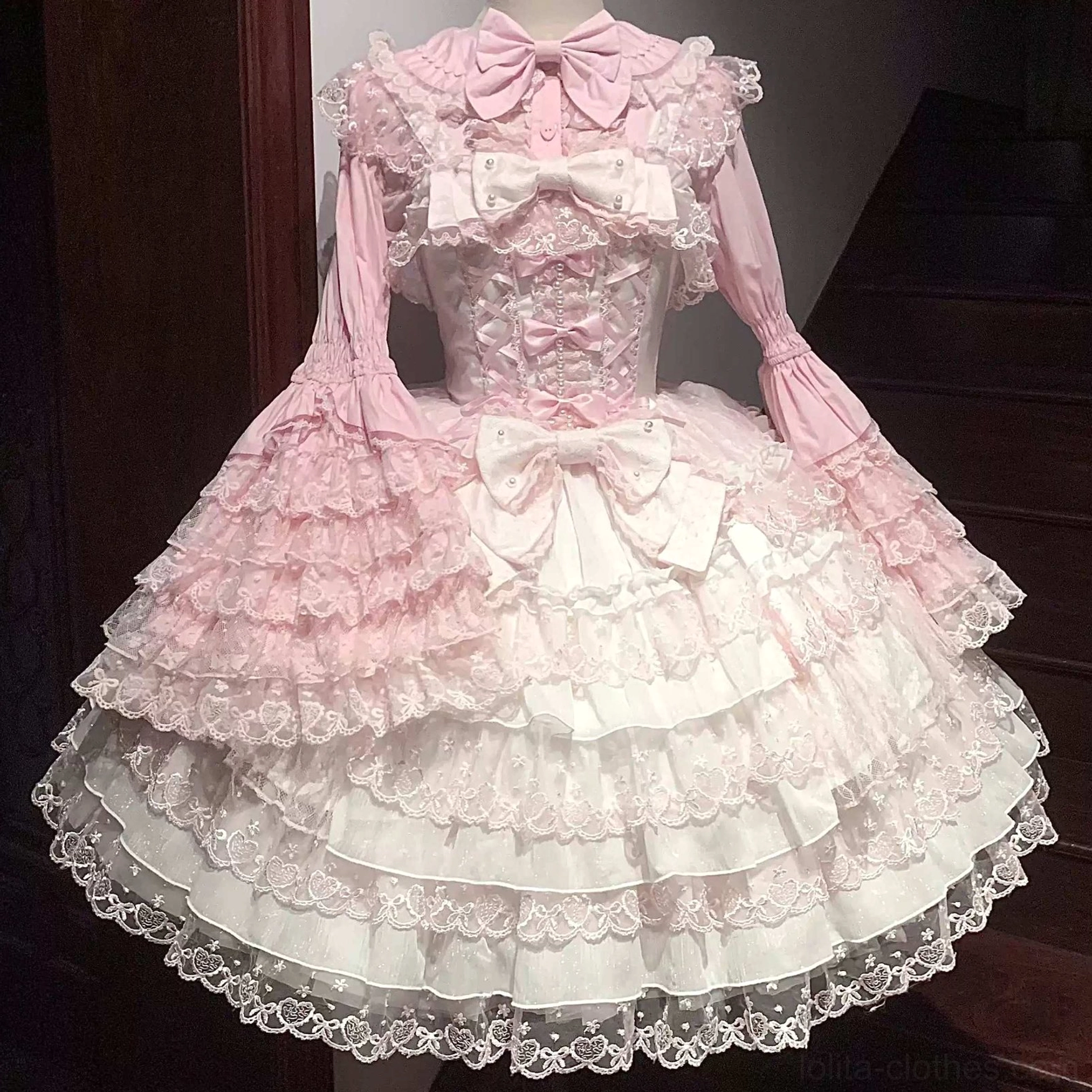 Sweet Lolita princess blouse in pink featuring Peter Pan collar with lace trim and tiered puffed sleeves adorned with bows and gauze overlay, front flat lay display