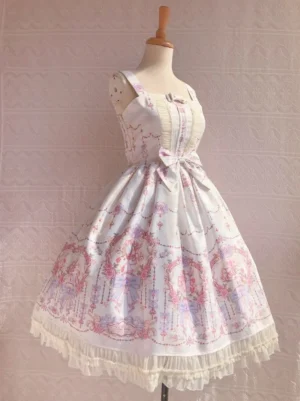 Three-quarter front angle view of sweet lolita printed JSK dress showing off-white base with pastel vintage botanical print wide shoulder straps and ruffled hem details