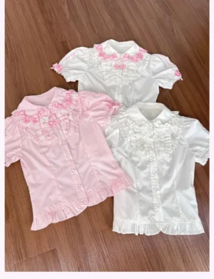 Sweet lolita puff sleeve blouses showing pink and white color options with decorative bow lace collar detail and fitted silhouette on wooden floor