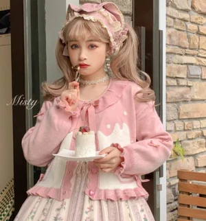 Sweet Lolita puff sleeve knit cardigan coat pink off-white color scheme with bow tie collar ruffled hem and cuffs outdoor portrait model