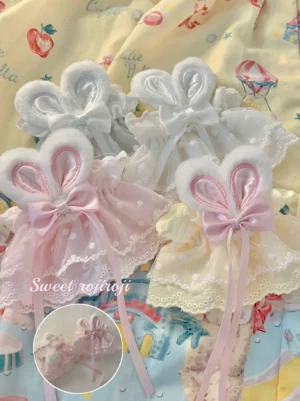 Sweet Lolita rabbit ear lace wrist cuffs with plush bunny ears satin bows and ribbon tails flat lay product photography