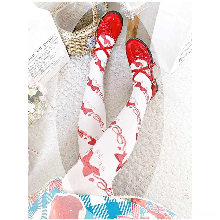 Sweet Lolita red bow print velvet knee-high stockings with white base fabric paired with red Mary Jane shoes and strawberry check Lolita skirt on carpet