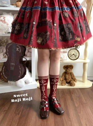 Wine red printed sweet Lolita calf socks paired with vintage red skirt and Mary Jane shoes in dollhouse setting showing crew length design with white vintage pattern prints