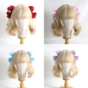Red Sweet Lolita satin bow hair clips pair worn on blonde curly wig mannequin front close-up view showing detailed bow design and metal alligator clip
