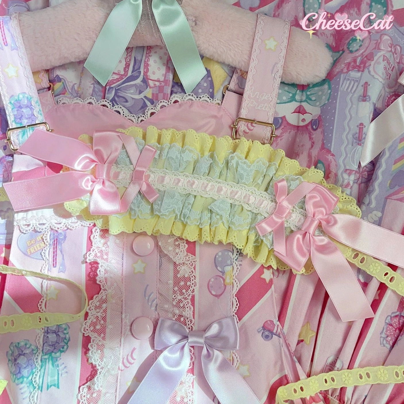 Sweet Lolita ruffled waist bow accessory headband displayed hanging on Lolita dress hanger with pastel yellow-green and pink color scheme