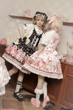 Back side view of two sweet lolita models wearing strawberry print salopette dresses with cross-strap design and decorative bows in vintage kitchen