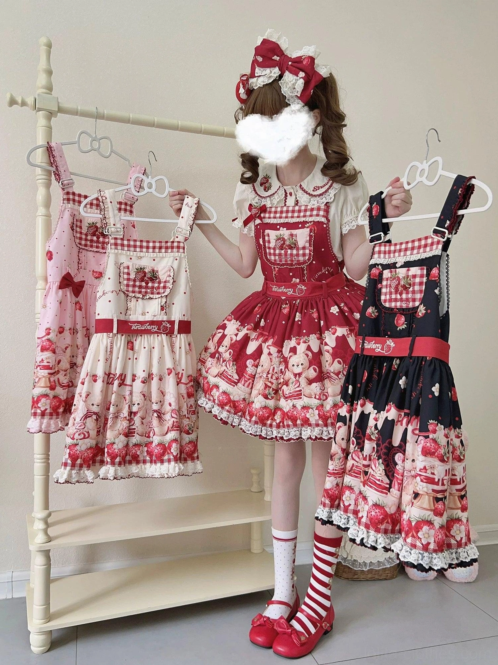 Two colorway options of sweet lolita salopette dress with bear and strawberry all-over print design, including black-red and pink-beige versions with ruffled lace hems