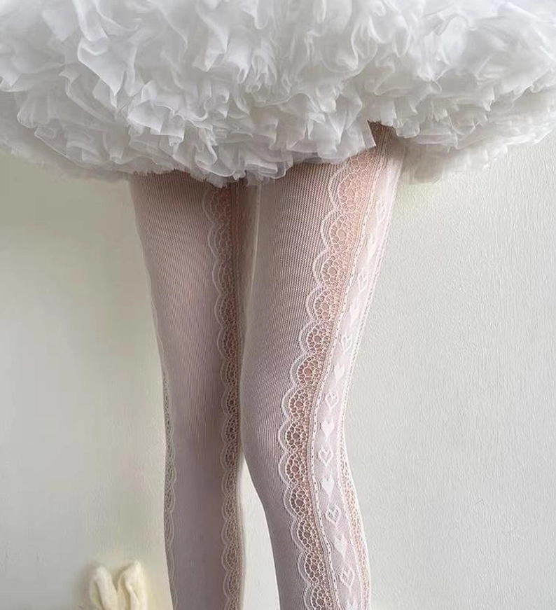 Sweet lolita lace patchwork pantyhose low-angle side view lower legs wearing white fluffy ruffled skirt scalloped lace side stripes detail