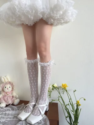 Front view of sweet lolita sheer floral calf socks featuring jacquard floral fabric and frilled lace cuffs classic sweet lolita style worn with white fluffy skirt and decorative props
