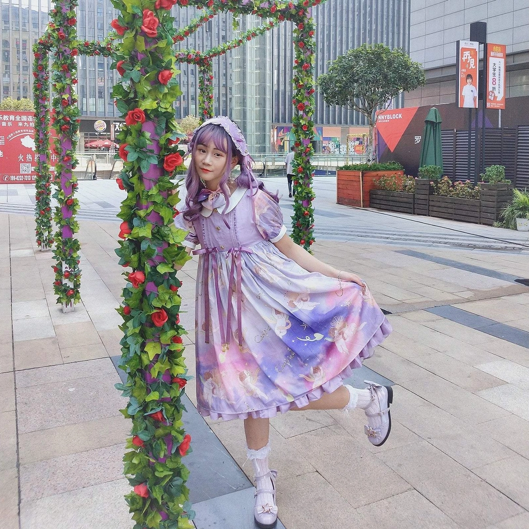 Full-body outdoor street style photo of girl wearing gradient purple lolita dress with matching hair accessory and sweet lolita mary jane shoes with star hardware and frilly lace socks