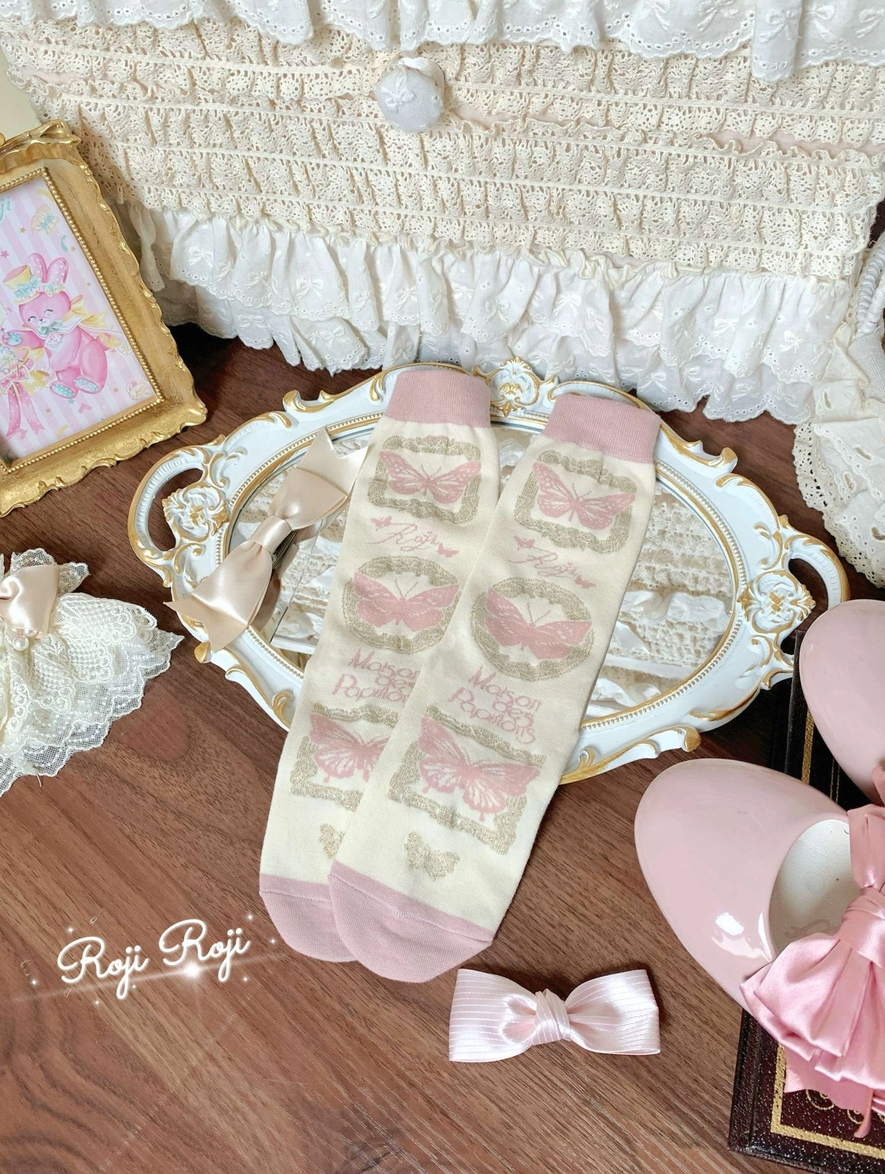 Black-gray Sweet Lolita mid-calf cotton socks with detachable cuff bow trim worn with coordinated Lolita outfit and accessories