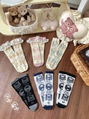 Assorted Sweet Lolita cotton socks flat lay display showing six pairs in different retro prints and colorways including mint green ivory and gray-pink with ruffled cuffs and detachable bows