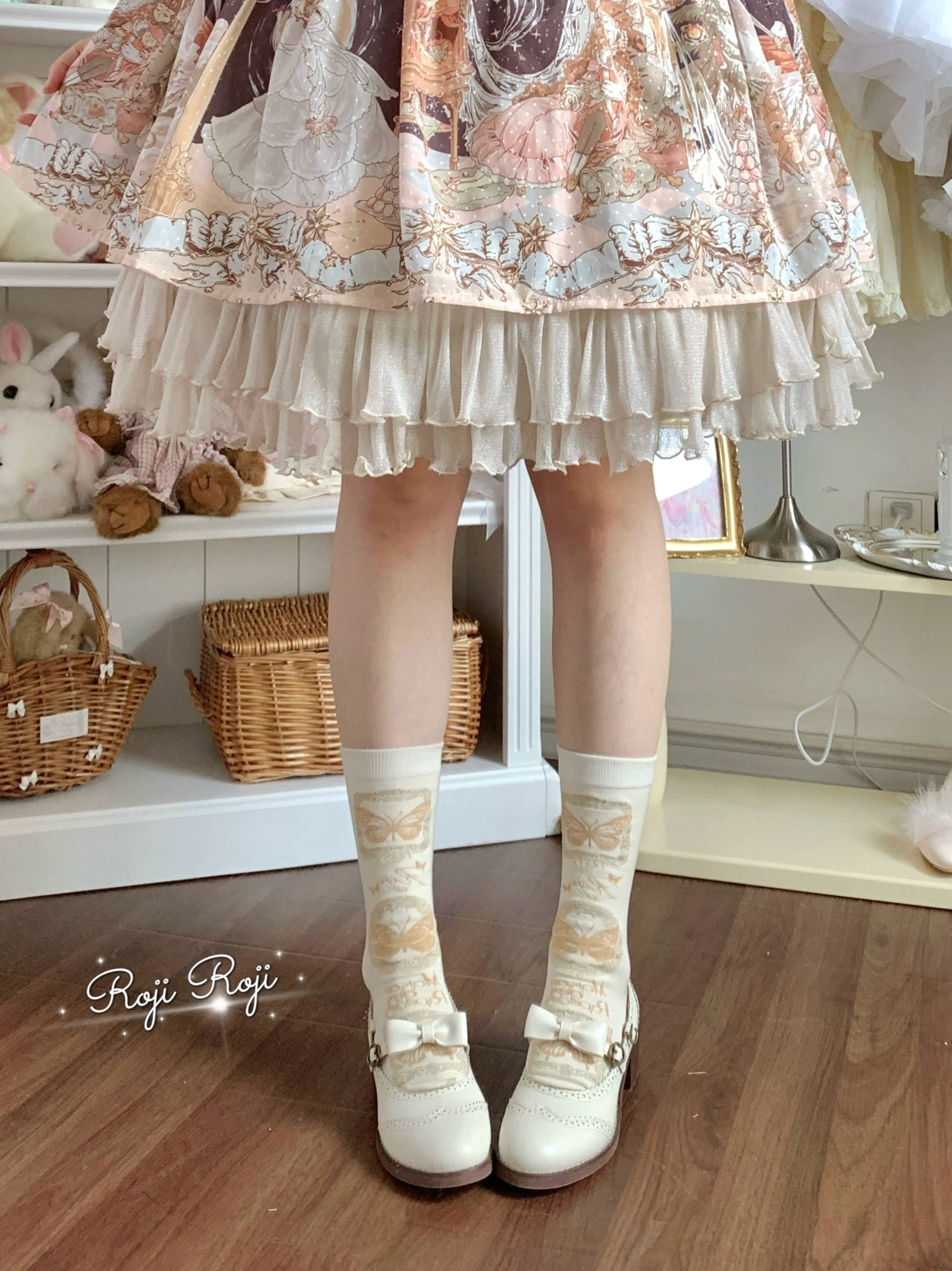 Cream base Sweet Lolita mid-calf cotton socks with subtle printed pattern and small bow decoration on ruffled cuff, paired with printed Lolita skirt and white bow Mary Jane shoes