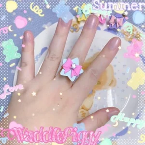 Adjustable sweet lolita star bow handmade ring pink blue layered design on hand with pastel background teddy bear plate