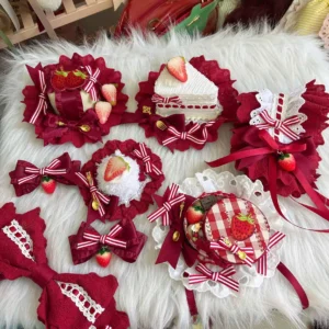 Flat lay display of assorted burgundy and pink Sweet Lolita hair accessories featuring strawberry charms, ruffled lace bows, miniature cake-shaped hairpins with gingham patterns on white fuzzy background