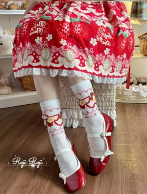 Sweet lolita strawberry print mid-calf socks white base red bow and strawberry details paired with red mary jane shoes and red strawberry print lolita skirt indoor boutique setting