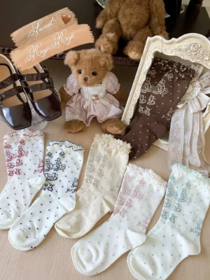 Sweet Lolita tea party socks collection overhead flat lay display multiple colorways bear prints polka dots ruffled lace cuffs vintage teddy bears Mary Jane shoes decorative elements