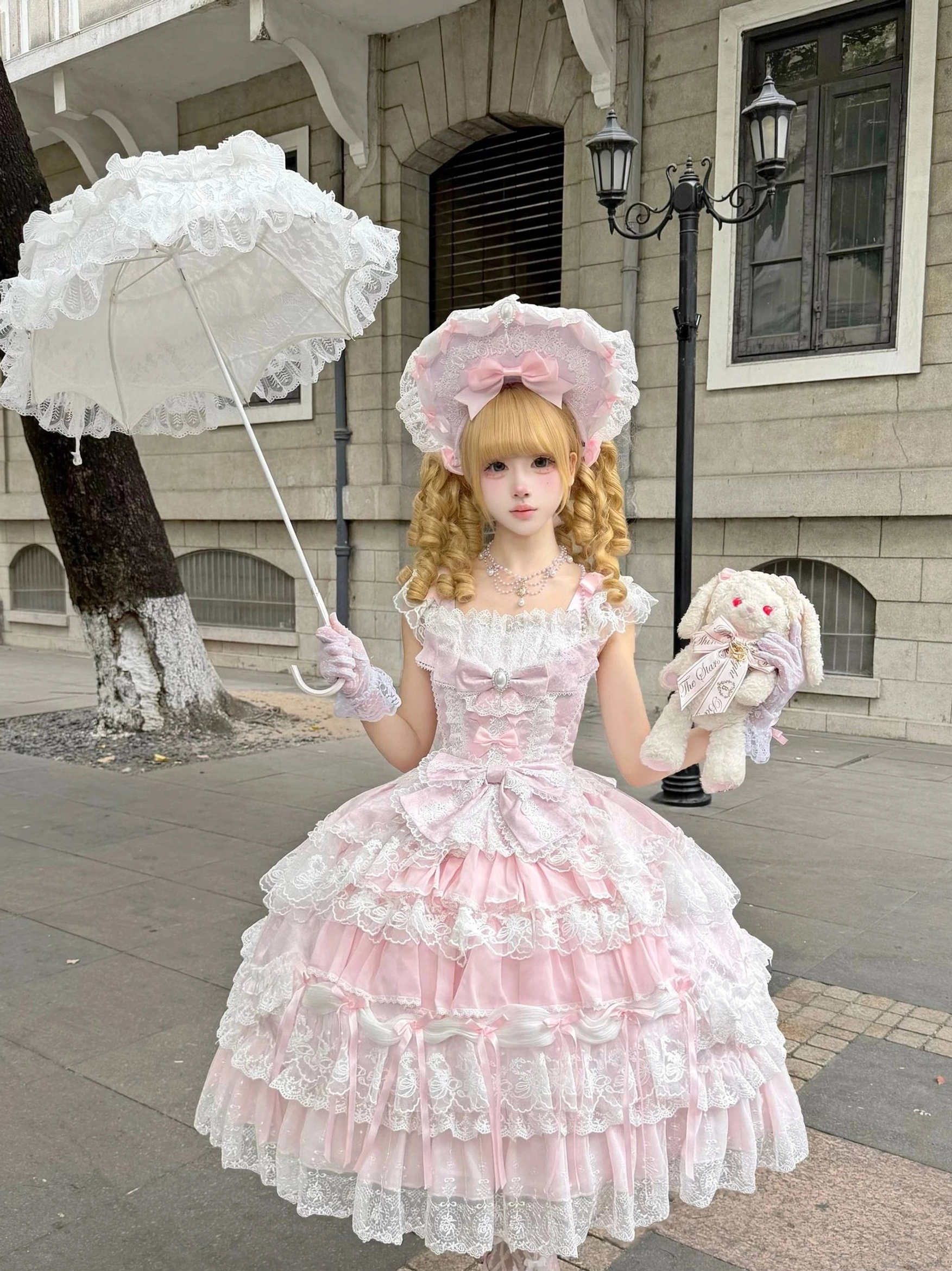 Detailed side profile of sweet lolita tiered JSK dress showing multi-layer lace ruffles and dimensional cake skirt structure