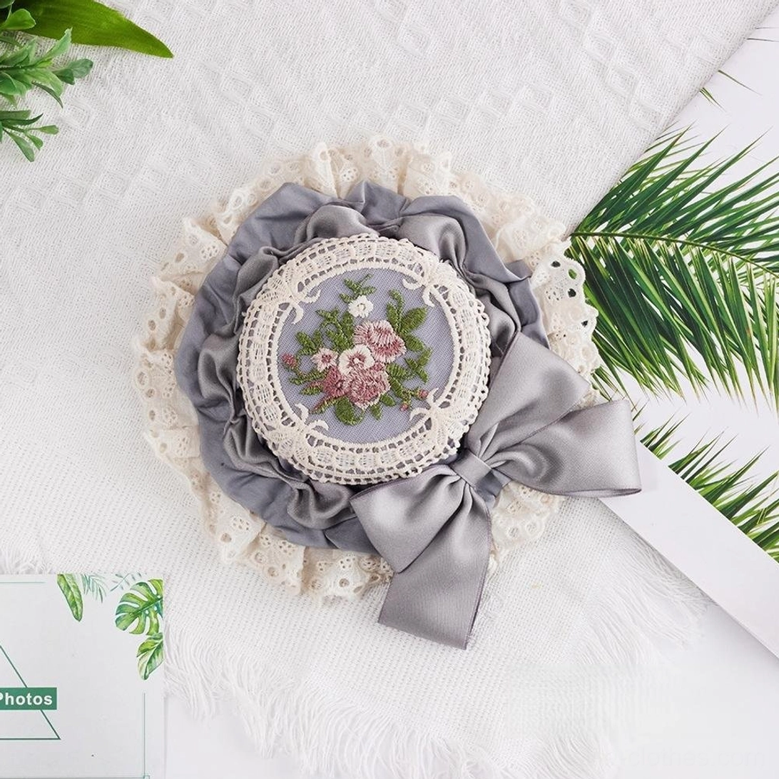 Gray Sweet Lolita top hat with floral hand-embroidery detail, coordinating gray satin bow, and refined white cotton lace trim accent